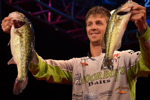 Chad Pipkens holds up his two biggest bass from day three on Beaver Lake