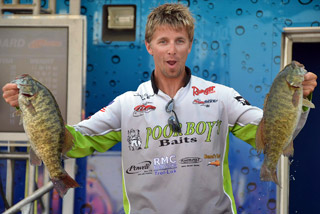 Third-place pro Chad Pipkens holds up his two biggest bass from day four on Lake Erie