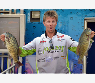 Third-place pro Chad Pipkens holds up his two biggest bass from day four on Lake Erie