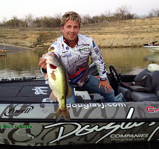 Chad Pipkens in his Douglas J-wrapped boat with a big largemouth bass caught during 2013 practice at Falcon Lake