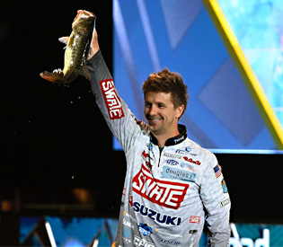 Chad Pipkens with a nice bass on stage at the 2022 Bassmaster Classic.